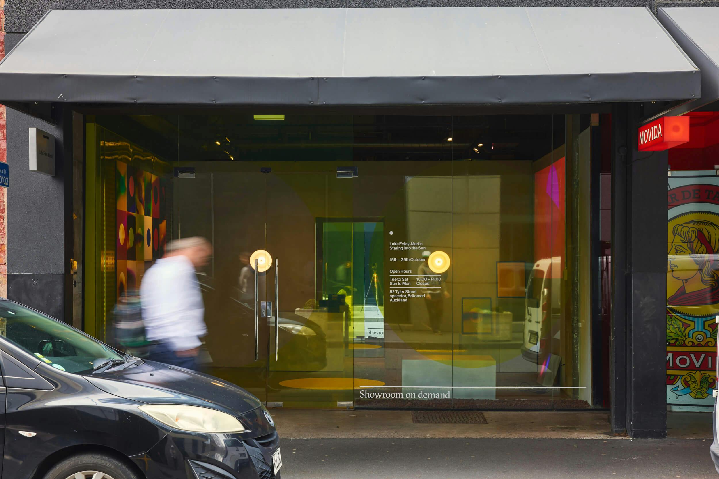 A glass-fronted storefront with black trim displays