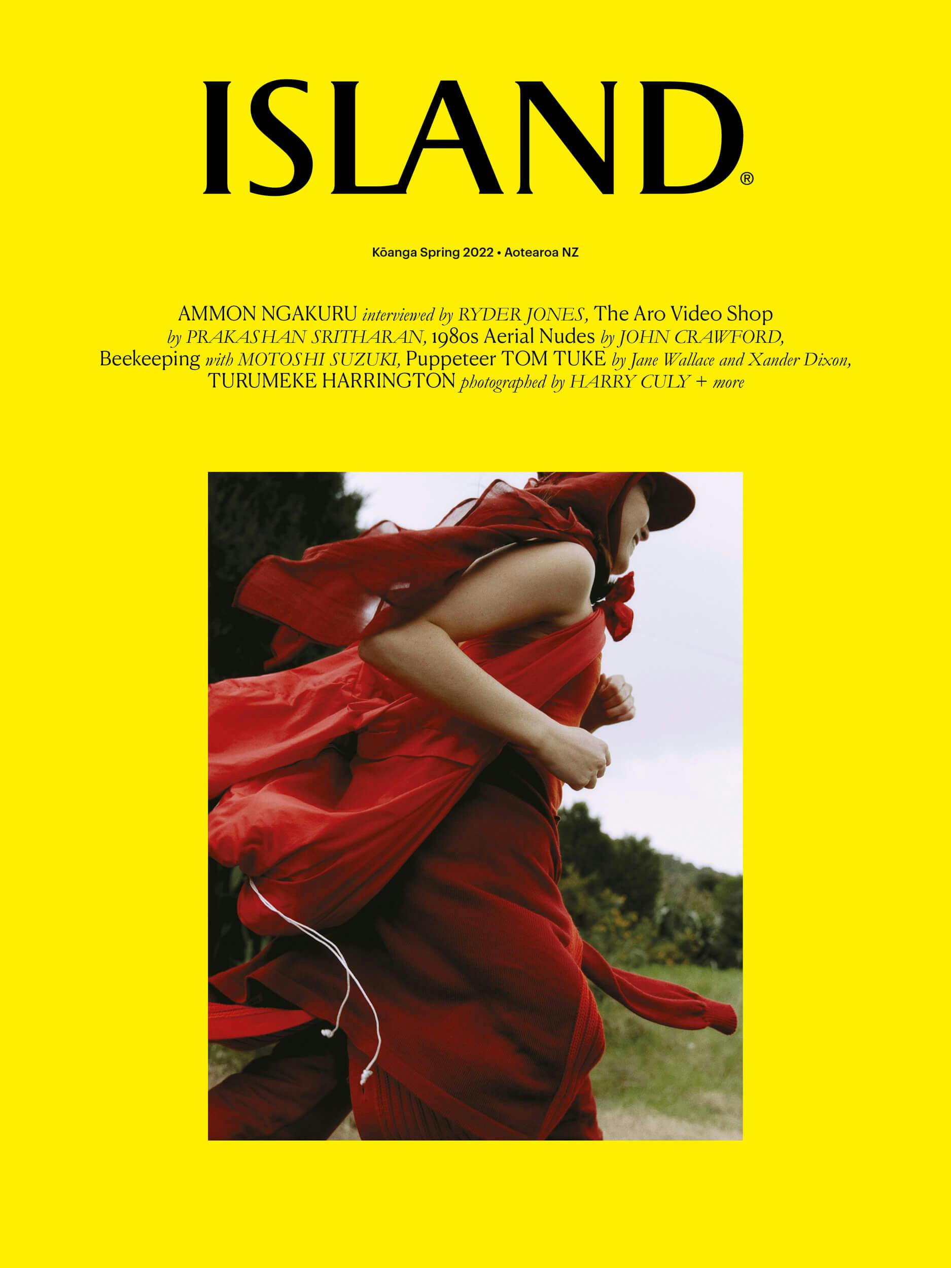 A person in a red dress is shown mid-motion against a grassy landscape under a cloudy sky. The image appears on the cover of a magazine titled