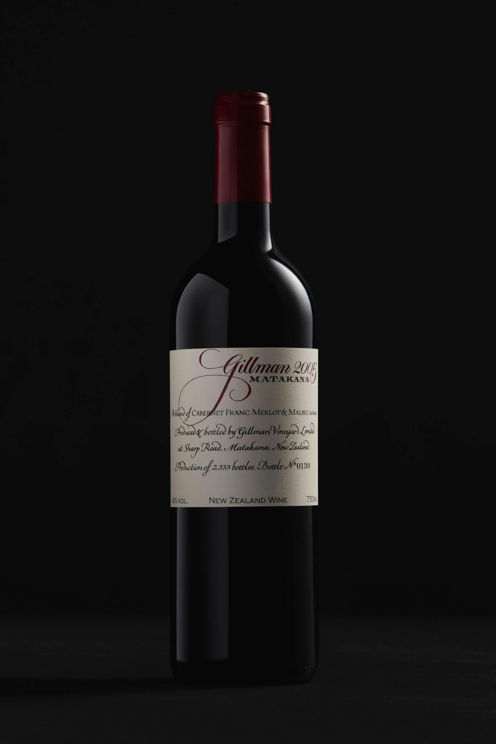 A bottle of red wine with a red foil top and a cream label reading