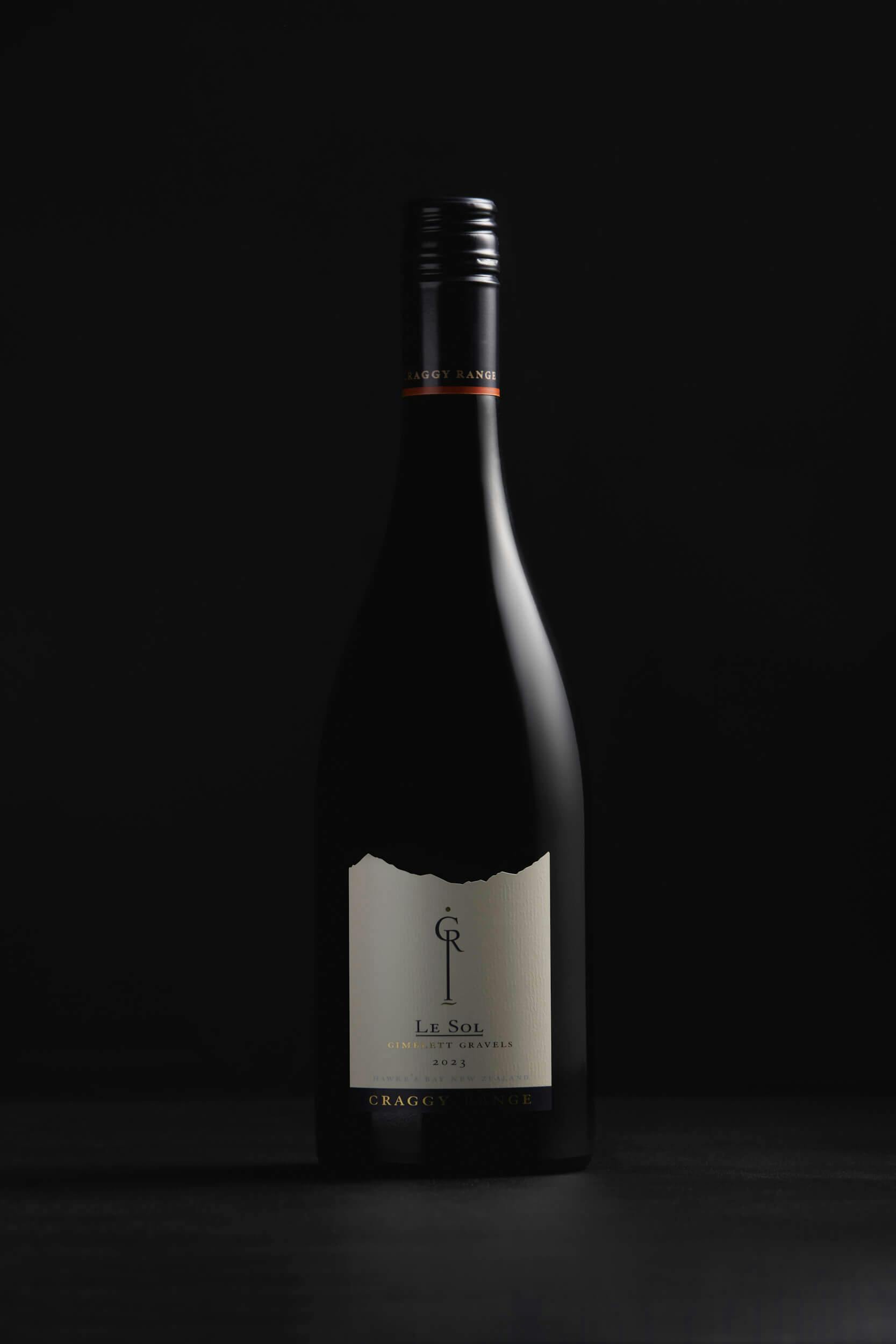 A single dark wine bottle with a black screw cap and a cream-colored label reading 